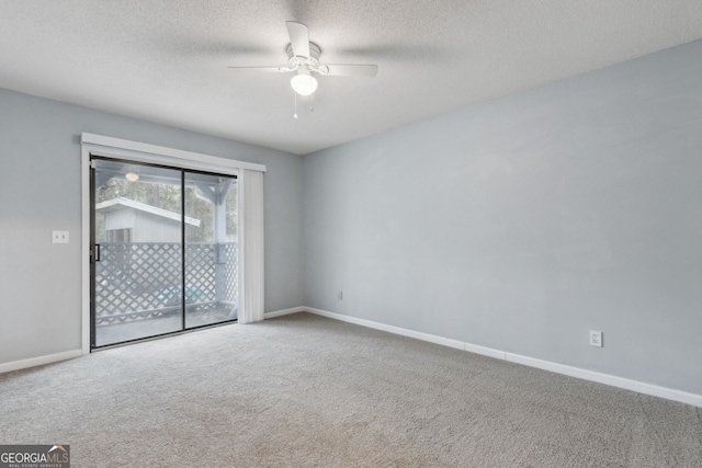 unfurnished room featuring carpet, baseboards, ceiling fan, and a textured ceiling