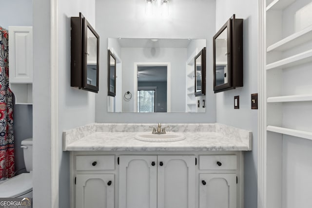 bathroom with toilet and vanity