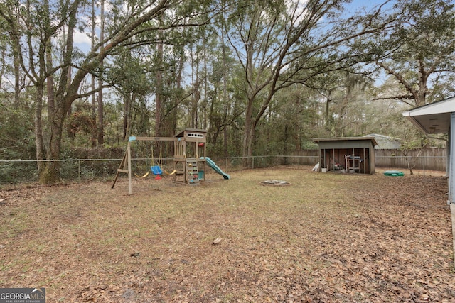 view of yard with a fenced backyard and a playground