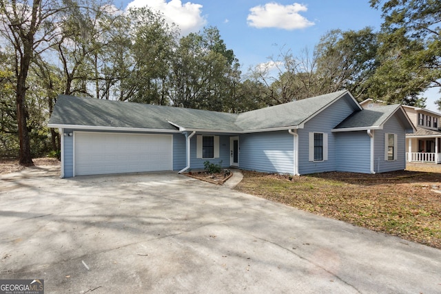 single story home featuring an attached garage and driveway