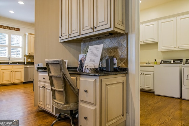 kitchen with light wood finished floors, dark countertops, washing machine and clothes dryer, stainless steel dishwasher, and recessed lighting