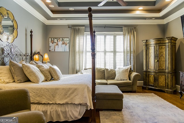 bedroom featuring ornamental molding, a tray ceiling, dark wood-style floors, and recessed lighting