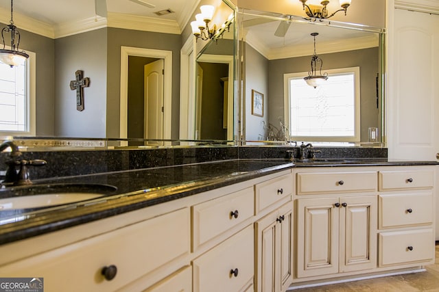 bathroom with double vanity, visible vents, a sink, and ornamental molding