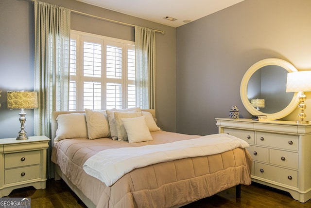 bedroom featuring dark wood-style flooring and visible vents