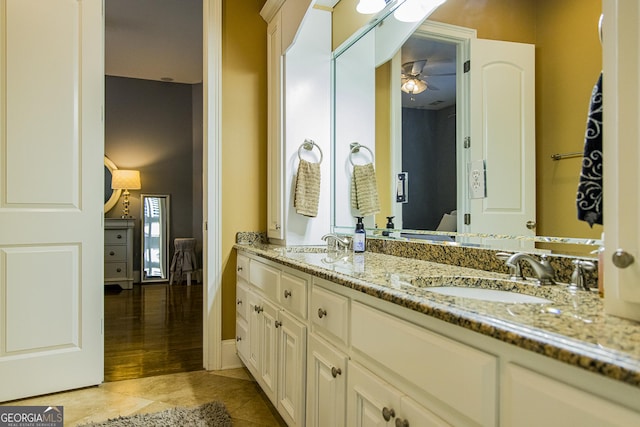 bathroom featuring double vanity, tile patterned flooring, ceiling fan, and a sink