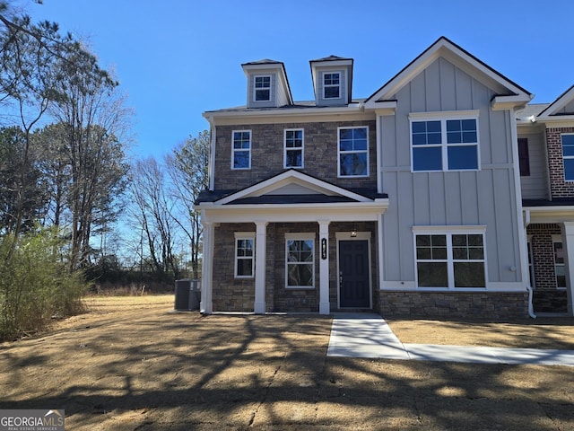 view of front facade featuring stone siding and board and batten siding