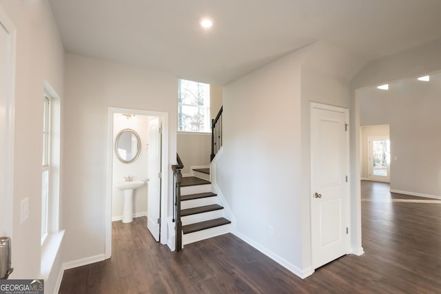 stairway with baseboards and wood finished floors