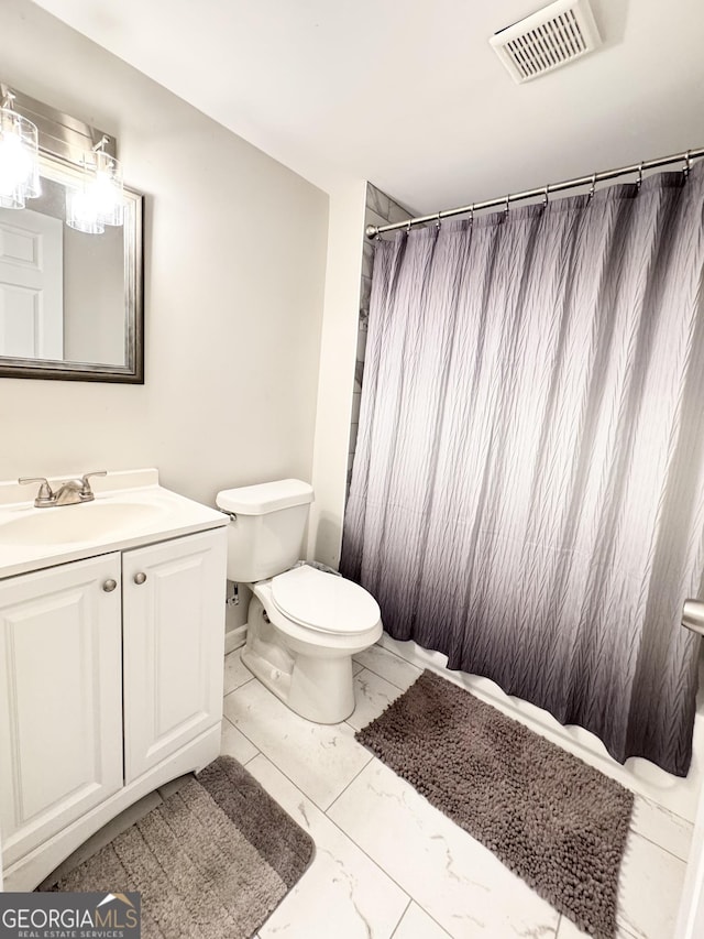 bathroom featuring visible vents, a shower with shower curtain, toilet, marble finish floor, and vanity