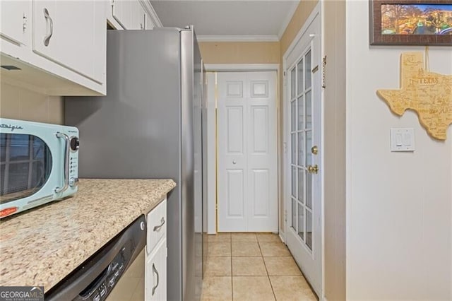 kitchen with light tile patterned floors, white cabinets, stainless steel appliances, crown molding, and light countertops