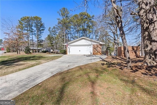 view of front of property featuring driveway, a garage, and a front lawn