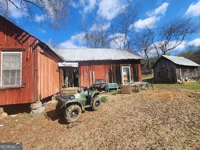 exterior space featuring metal roof and an outdoor structure