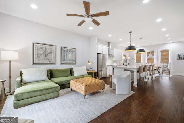 living area with dark wood-style floors and recessed lighting