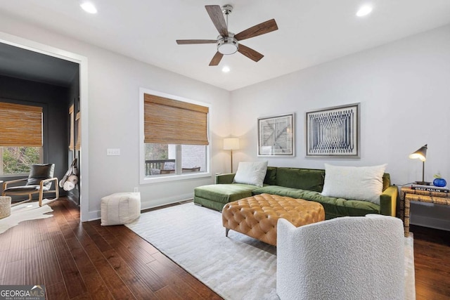 living area featuring baseboards, plenty of natural light, dark wood finished floors, and recessed lighting