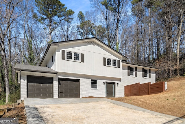 view of front of house with driveway, an attached garage, and brick siding