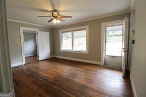 interior space with ceiling fan, baseboards, dark wood-type flooring, and crown molding