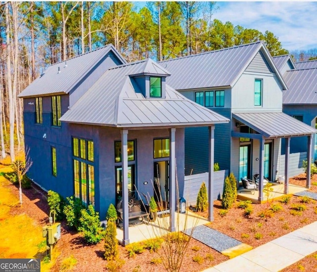 modern farmhouse featuring a standing seam roof and metal roof