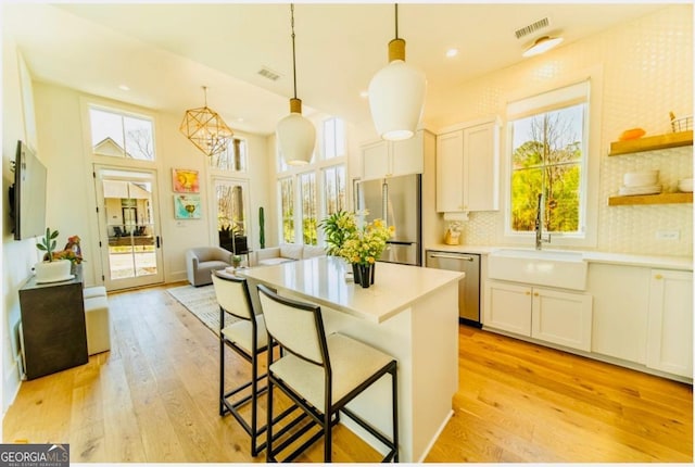 kitchen with white cabinetry, stainless steel appliances, and light countertops