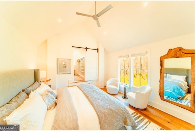 155 Mado Ln, Palmetto, GA 30268 - bedroom with a barn door, baseboards, lofted ceiling, ceiling fan, and wood finished floors