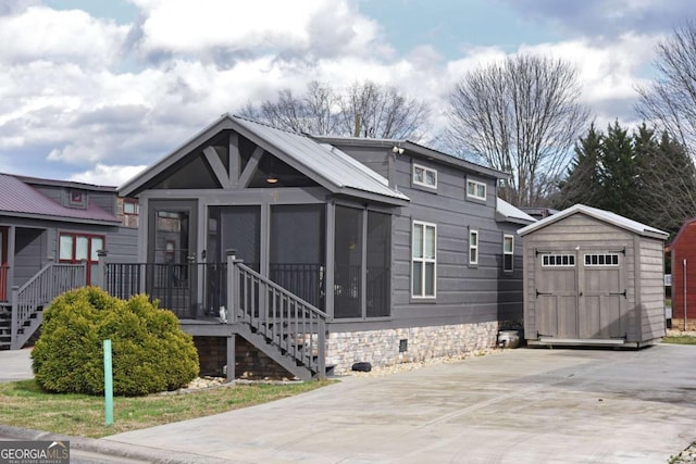 view of front of property featuring crawl space, a storage shed, stairway, and an outbuilding