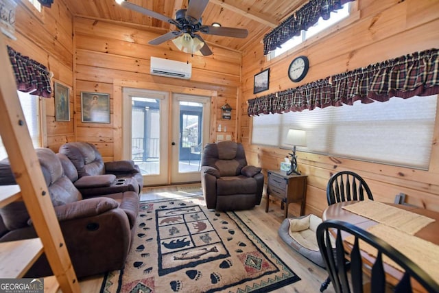 living area featuring wooden ceiling, wood walls, french doors, light wood finished floors, and a wall mounted air conditioner