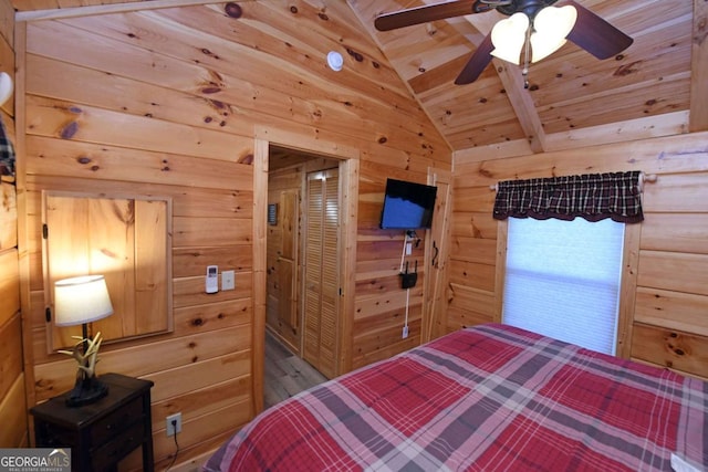 bedroom featuring wood ceiling, vaulted ceiling, wooden walls, and wood finished floors