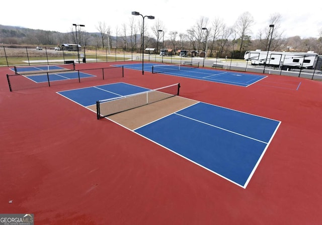 view of sport court featuring community basketball court and fence