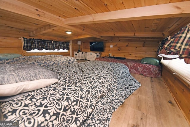 bedroom with wood ceiling, beam ceiling, wooden walls, and wood finished floors