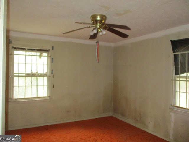 empty room with a healthy amount of sunlight and a ceiling fan