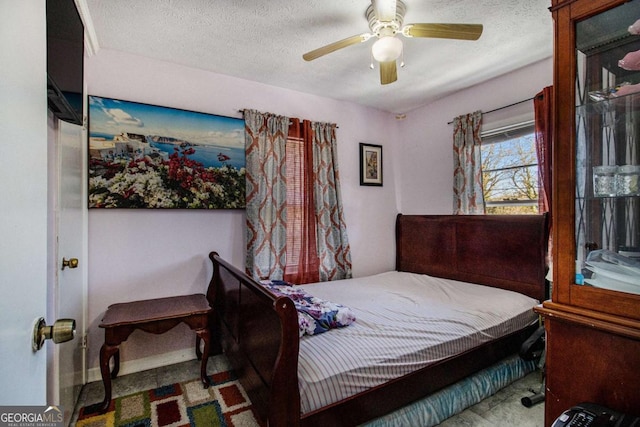 bedroom featuring baseboards, a ceiling fan, and a textured ceiling