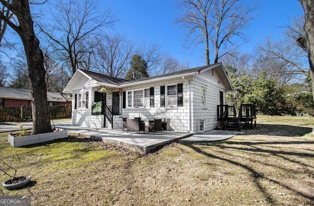 view of front of home featuring a wooden deck, fence, a patio, and a front yard