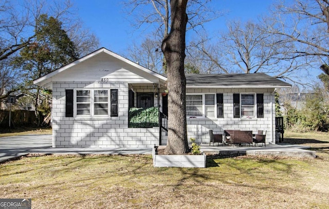 bungalow-style house with a front yard