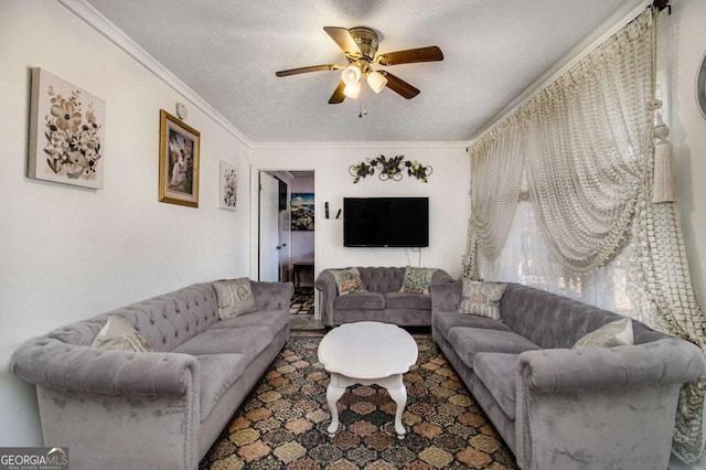 living area featuring crown molding, a textured ceiling, and ceiling fan