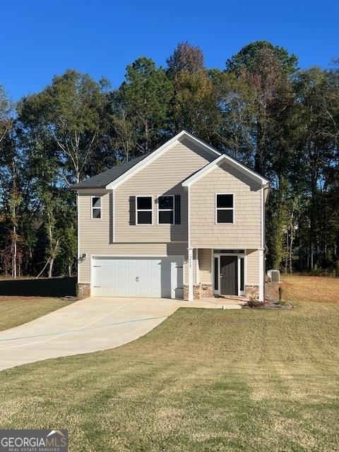 view of front of house with a garage, a front yard, and concrete driveway