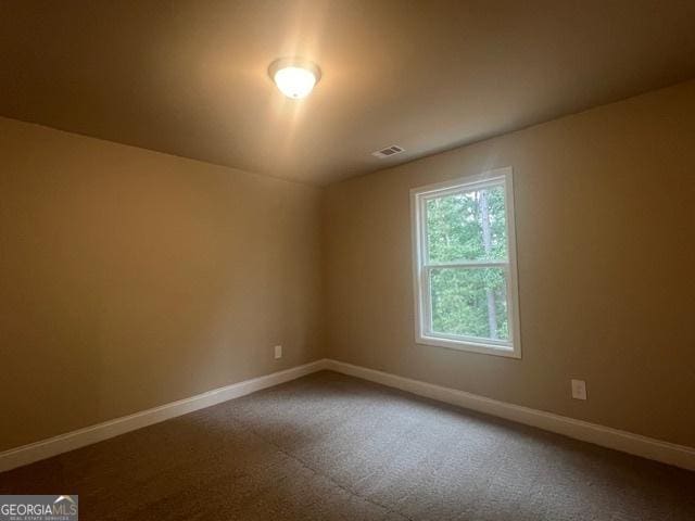 spare room with visible vents and baseboards