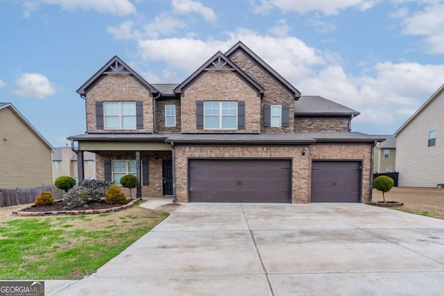 craftsman-style house with a garage, concrete driveway, and brick siding