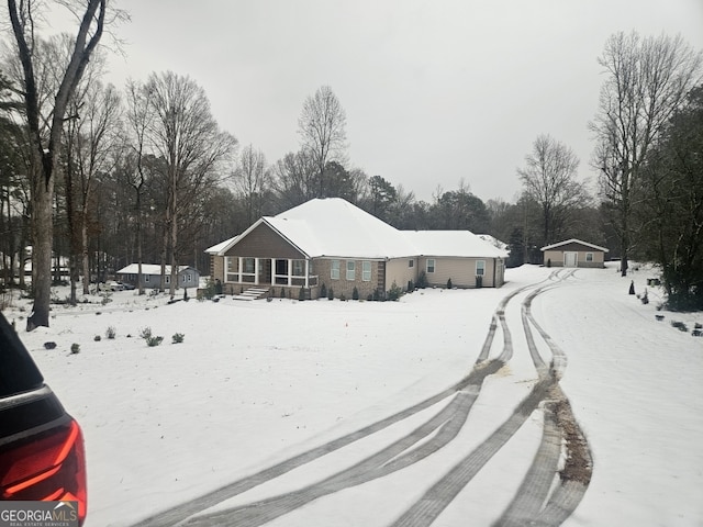 view of snow covered back of property