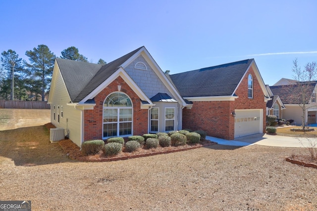 traditional-style home with a garage, driveway, brick siding, and cooling unit