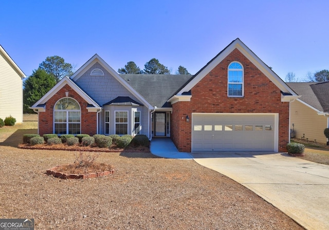 traditional-style house with driveway and brick siding