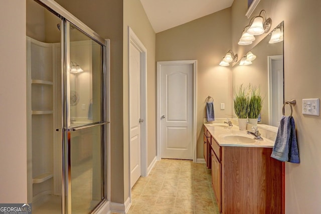 full bath with lofted ceiling, a stall shower, and double vanity