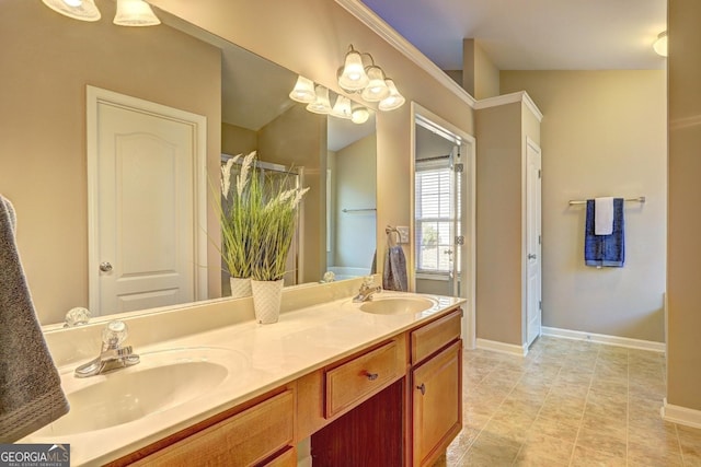 full bathroom with double vanity, a sink, and baseboards