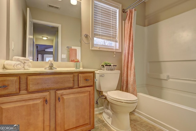 bathroom featuring tile patterned flooring, toilet, vanity, visible vents, and shower / bath combo with shower curtain