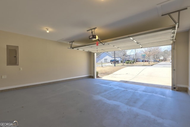 garage featuring a garage door opener, a residential view, electric panel, and baseboards