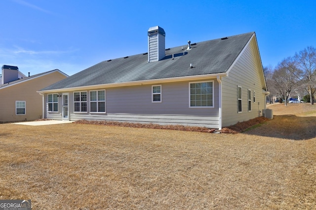 back of house with a patio area, a chimney, and central AC unit