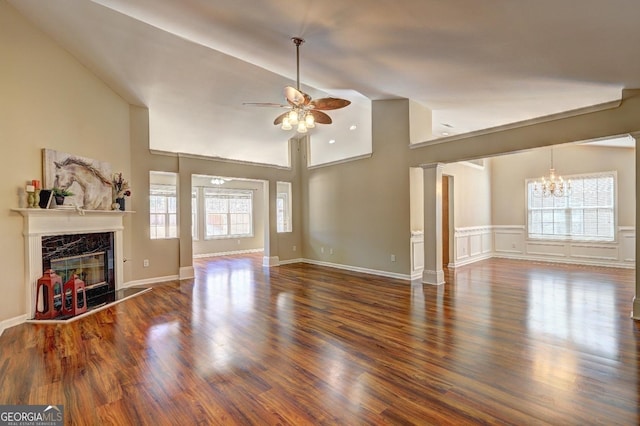 unfurnished living room with wood finished floors, plenty of natural light, and a premium fireplace