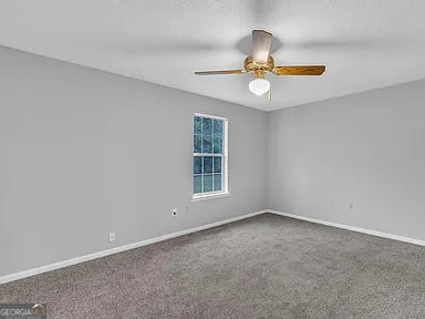 unfurnished room featuring ceiling fan, baseboards, and carpet flooring