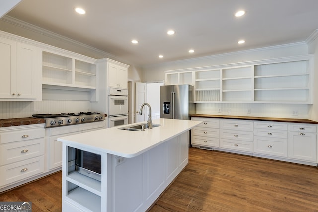 kitchen featuring stainless steel appliances, a sink, and open shelves