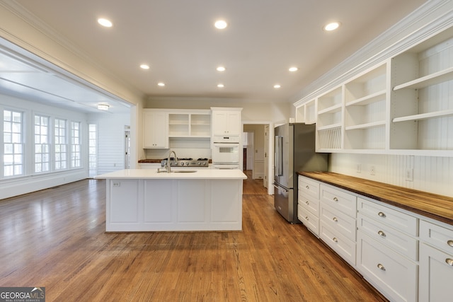 kitchen with open shelves, high end fridge, and white cabinetry