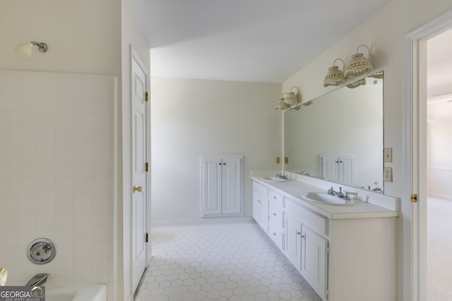 full bath with double vanity, shower / bath combination, and a sink