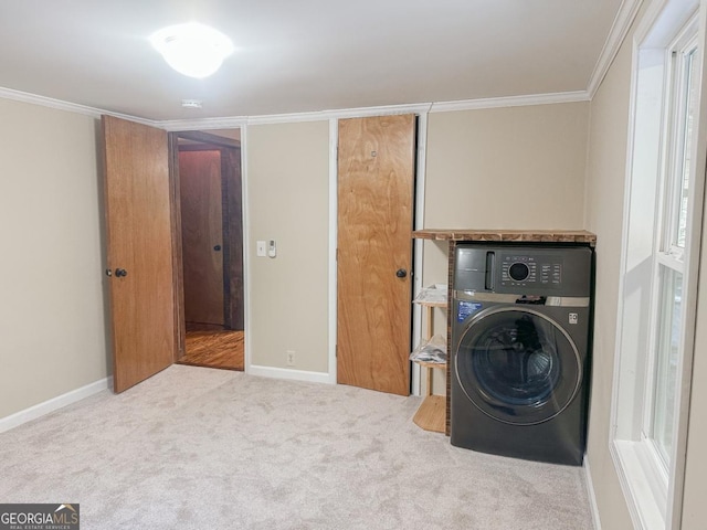 laundry room with carpet floors, washer / clothes dryer, ornamental molding, and laundry area