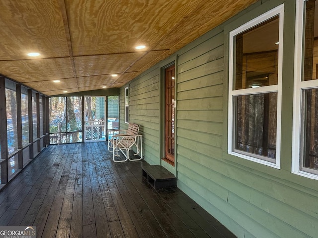 unfurnished sunroom with wood ceiling